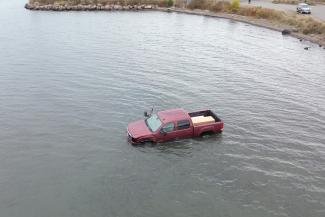 Suspect charged after stolen vehicle driven into lake